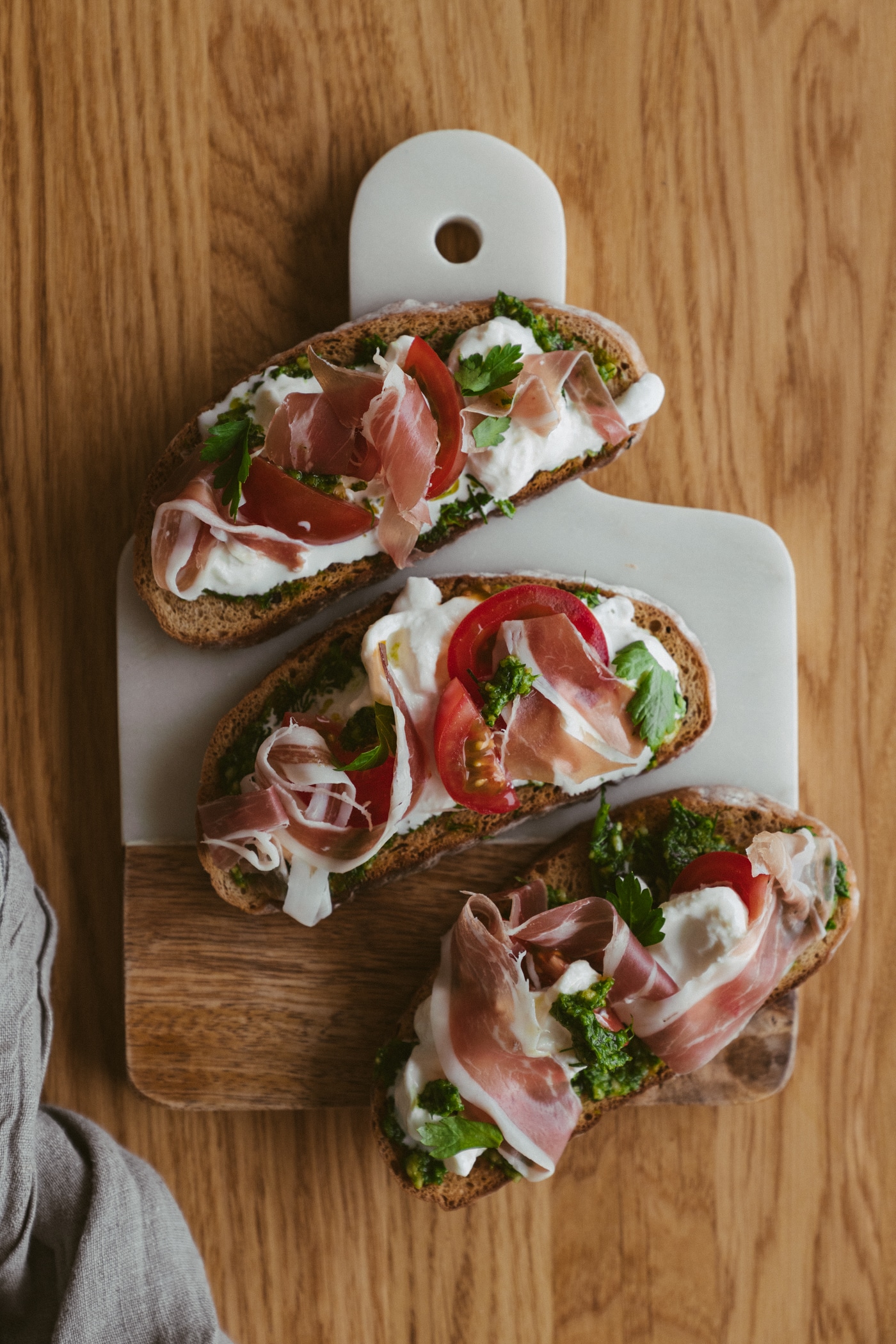 Stracciatella Prosciutto Toasts With Fresh Herb Pesto